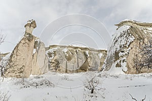 Unique geological rock formations under snow in Cappadocia, Turk