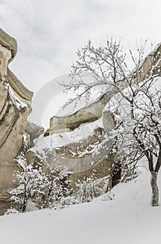 Unique geological rock formations under snow in Cappadocia, Turk