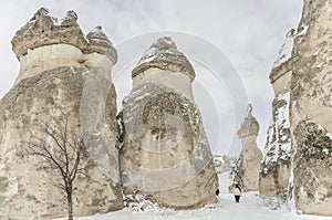 Unique geological rock formations under snow in Cappadocia, Turk