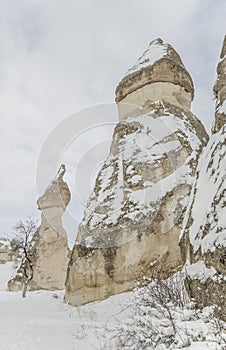 Unique geological rock formations under snow in Cappadocia, Turk