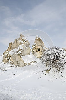 Unique geological rock formations under snow in Cappadocia, Turkey