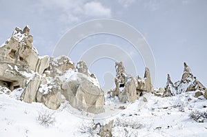 Unique geological rock formations under snow in Cappadocia, Turkey