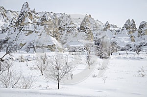 Unique geological rock formations under snow in Cappadocia, Turkey