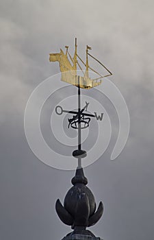 The unique gold covered weather vane in a shape of a sailing ship on the roof of the Dutch Naval Academy in Den Helder.