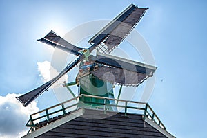 Unique green traditional Dutch Windmill and cottages in vintage