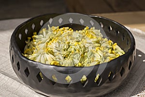 Unique handmade dish with cowslips in sunlight
