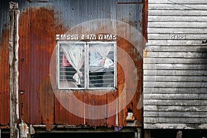 Unique happy new year 2022 postcard with rusty and wooden poor house