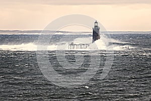 Unique High Tide Causes Huge Waves to Break Against Distant Lighthouse