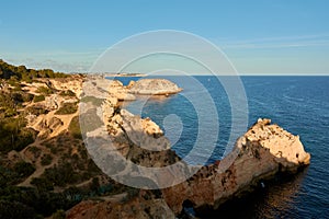 Unique limestone rock formations with arches and caves near Alvor village in Portugal