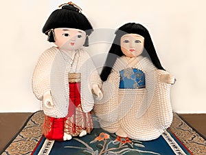 Unique male and female porcelain Asian Dolls Standing on Oriental rug.