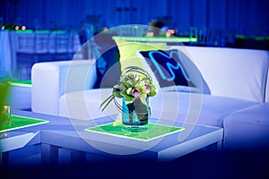 Unique orchid flower arrangement set up for a wedding party in a ballroom with lucite chairs and decoration photo