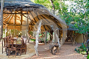 Luxury safari lodge, outdoor patio with thached roof in South Africa
