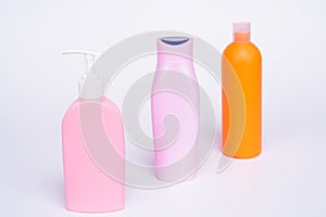 Unique packaging. Toiletry bottles isolated on white. Shampoo, conditioner and lotion bottles in row