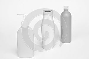 Unique packaging. Toiletry bottles isolated on white. Shampoo, conditioner and lotion bottles in row