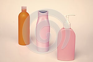 Unique packaging. Toiletry bottles isolated on white. Shampoo, conditioner and lotion bottles in row
