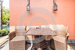 Unique patio area with wooden furniture surrounded by a garden.