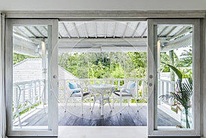 Unique patio area with wooden furniture surrounded by a garden.