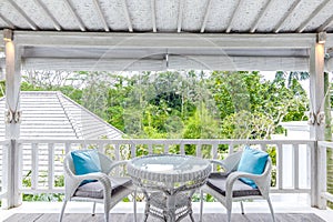 Unique patio area with wooden furniture surrounded by a garden.