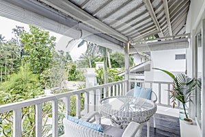 Unique patio area with wooden furniture surrounded by a garden.