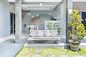 Unique patio area with wooden furniture surrounded by a garden.