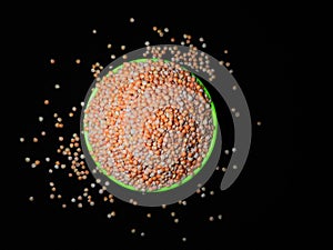 Unique picture of masoor dal, lentils or legumes in a green cup under dark background