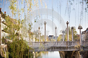 Unique Plecnik arhitecture of Cobblers bridge seen trough willow branches in old medieval city center of Ljubljana