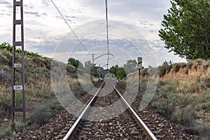 Unique railroad line at the sunset. Train railway track . Low clouds over the railroad