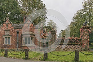 Unique red brick gate house in early autumn