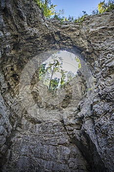 Unique rock formation of a hole on a rock cliff at Rakov Skocjan in Slovenia