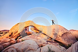 Unique rock formations with female climber at sunset.