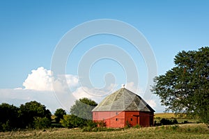 Unique round red barn surrounded by open farmland in rural Illinois.