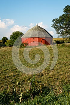 Unique round red barn surrounded by open farmland in rural Illinois.