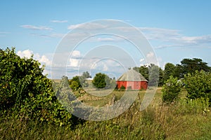 Unique round red barn surrounded by open farmland in rural Illinois.