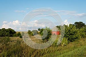 Unique round red barn surrounded by open farmland in rural Illinois.