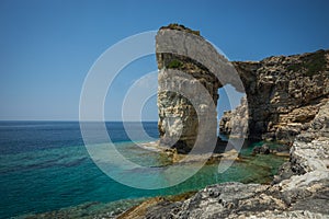 Unique and scenic arch in the cliffs, Paxi, Greece