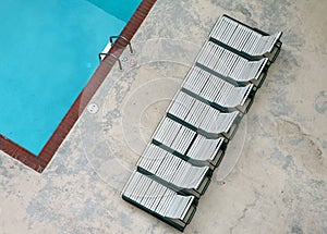 Unique shot of pool with lounge chairs