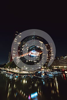 Unique skyscraper in the harbour of Rotterdam during the night with artificial lighting. Modern part of the Netherlands