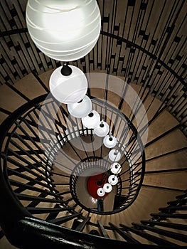 A unique spiral staircase with beautiful lights.