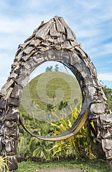 A unique structure made with coconut palm husks at Captain\'s Peak Garden, with views of the Chocolate Hills