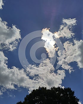 Unique sunburst and cloudy blue sky