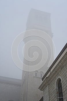 A unique view of an old tower into the clouds photo