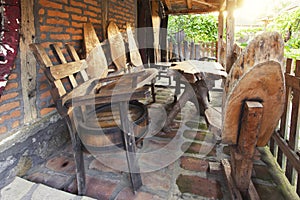 Unique wooden chairs and table on porch