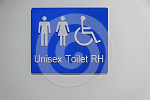 Unisex and Disabled toilet sign on white wall.
