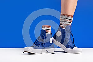 Unisex shoes and socks for sports, blue background. Copy space.