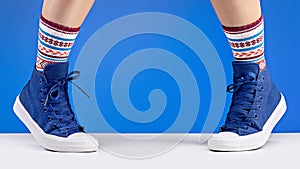 Unisex shoes and socks for sports, blue background. Copy space.