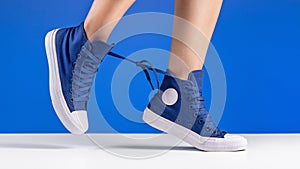 Unisex shoes and socks for sports, blue background. Copy space.