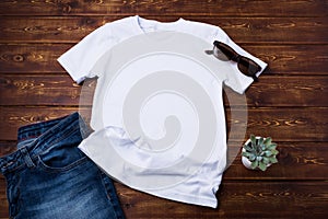 Unisex T-shirt mockup with jeans and succulent photo