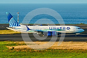 United Airlines Boeing airplane arriving in Ponta Delgada Azores with the ocean in the background