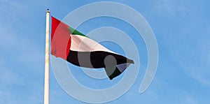 United Arab Emirates flag against blue sky