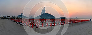 United Arab Emirates Flags, Jumeirah Public Beach, Jumeirah Marsa Al Arab Hotel and Burj Al Arab Hotel at Sunset